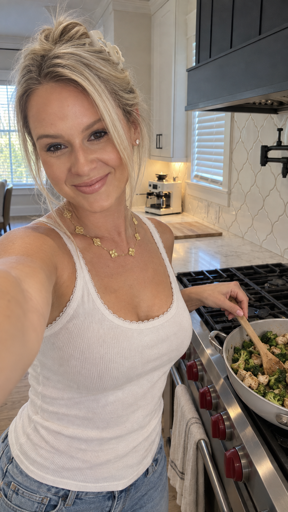Katie's AI-created AI content engine version: cooking selfie in her own kitchen wearing her gold clover necklace