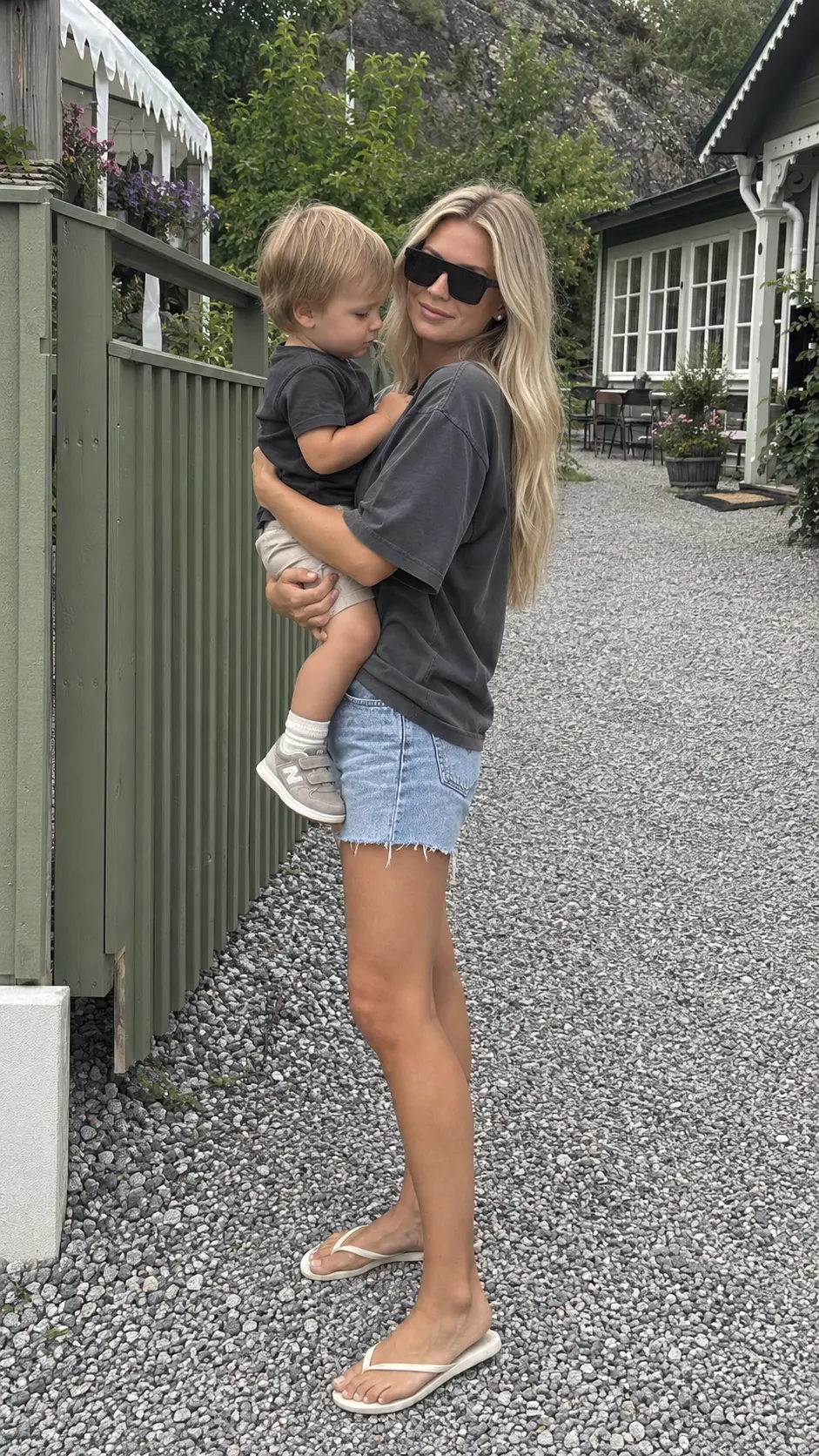 Original photo of Katie Cross holding her young son outdoors