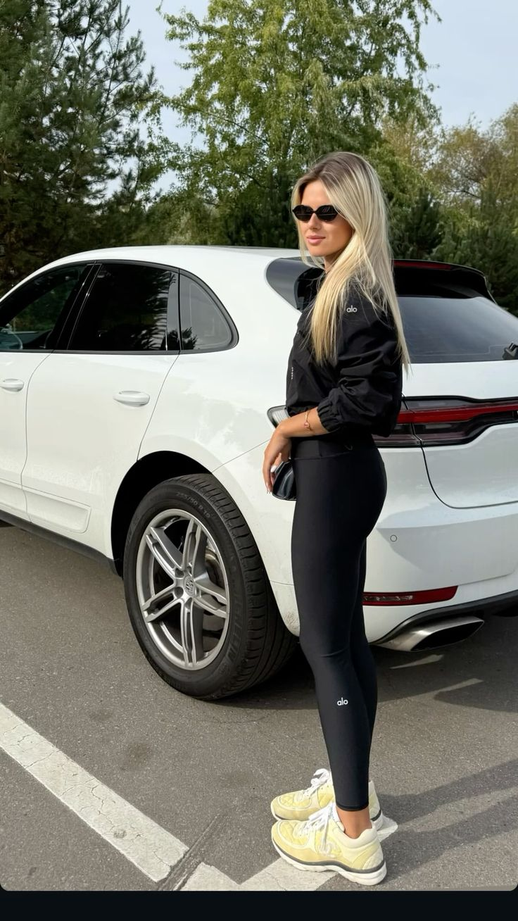 Pinterest inspiration: a blonde woman in black activewear and sunglasses beside a white Porsche SUV